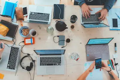 People collaborating on laptops in a modern workspace
